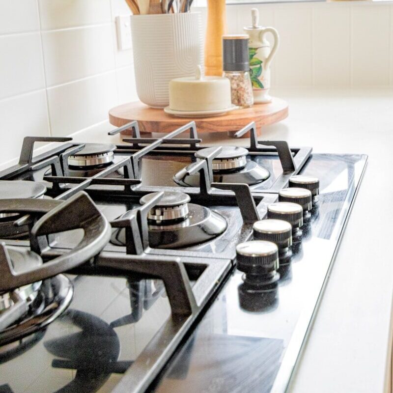 black and white chess pieces on black and silver gas stove