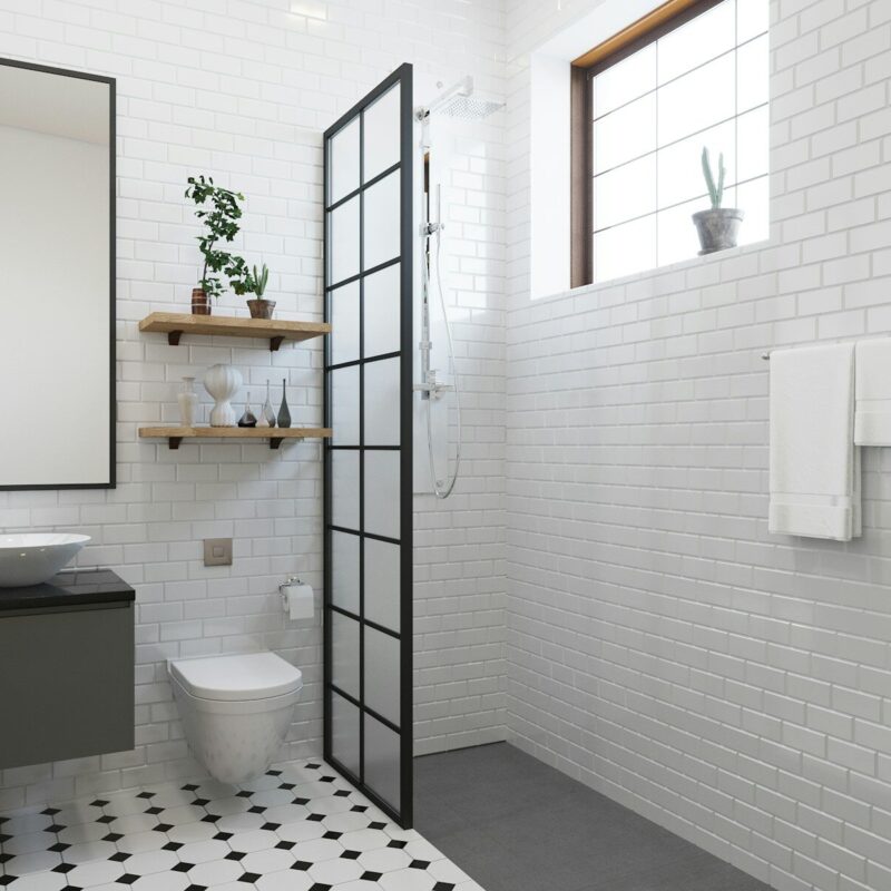 a bathroom with a toilet, sink, and shower